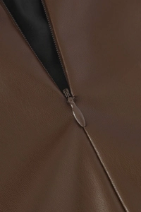 Gros plan d'une jupe en cuir PU marron avec une fermeture éclair invisible et lisse