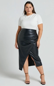 Detail of high waist faux leather midi skirt with side draped folds and front slit