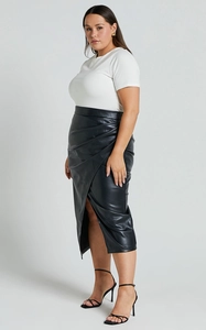 Detail view of high waist black faux leather skirt with ruched front and side slit