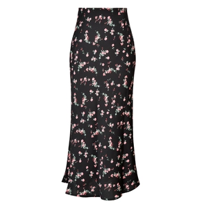 Close-up of black satin midi skirt featuring pink floral patterns and a side slit