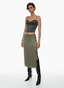 Detail of high waist slit satin skirt and corset top set with high boots
