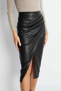 Close-up of black PU leather skirt featuring detailed draped folds and a center split