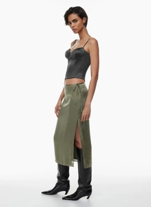 Detail view of olive green satin skirt featuring side slit and waist tie ribbon detail