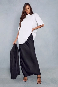 Detail of high-waist satin maxi skirt with smooth texture and elegant drawstring waist