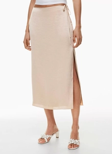 Detailed close-up of champagne satin skirt featuring high waist tie and side slit detail