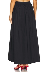 Detail of high waist elastic waistband and pleated fabric on black cotton maxi skirt