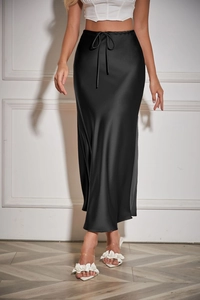 Detail view of smooth satin texture and drawstring waist on black high-waisted midi skirt