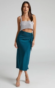 Detail of peacock blue satin midi skirt with side drawstring ruching and slit design