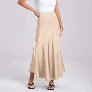 Détail d'une élégante jupe midi en satin champagne taille haute avec texture soyeuse