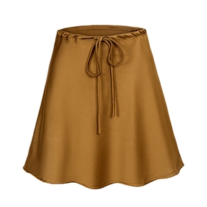 Detail of satin mini skirt with drawstring waist and scalloped hem in bronze brown color