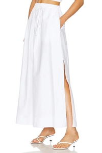 Detail of high waist drawstring belt and side slit on this white cotton maxi skirt