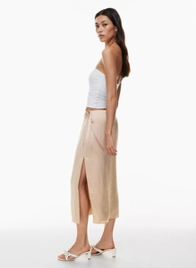 Detail of champagne satin midi skirt with elegant side slit and drawstring waist tie