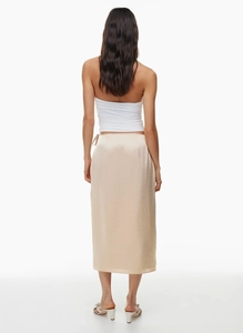 Back view of high waist champagne satin midi skirt with elegant high slit and glossy fabric