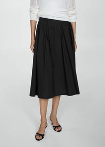 Close-up detail of high waist pleated A-line skirt with structured flared hem in black