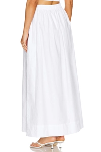 Detailed close-up of elastic high waist and natural cotton texture on white maxi skirt