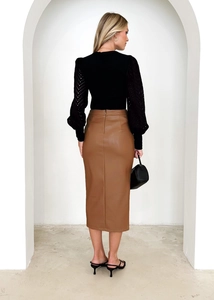 Detail of high waist brown PU leather midi skirt with back zipper and side slit