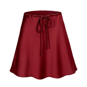 Detail of burgundy satin skirt with drawstring waist and delicate ruffled hem edges