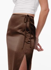 Detail view of brown satin midi skirt featuring side tie-up waist and elegant side slit