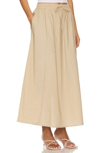 Detailed view of elastic high waist with drawstring on beige cotton maxi skirt