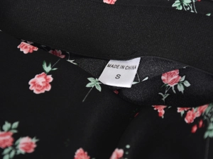 Detailed view of elastic waist on S-size floral satin skirt with delicate pink flowers