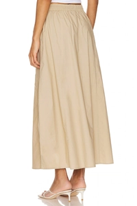 Side view of beige high waist cotton maxi skirt featuring an elastic waistband and pockets