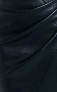 Detailed close-up of high-waisted black PU leather skirt texture with premium grain finish