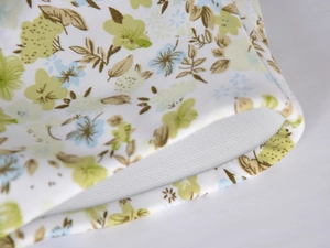 Detail view of floral satin skirt showing high-quality white mesh lining and stitching