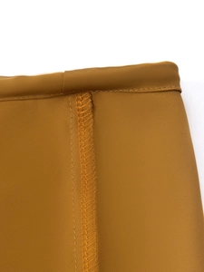 Detail of the high-quality overlock stitching on camel satin drawstring mini skirt