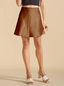 Detailed texture of brown satin mini skirt with subtle silk sheen and gathered fabric