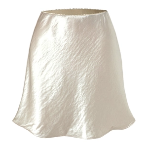 Detail of champagne satin mini skirt featuring delicate lace trim and textured silk fabric