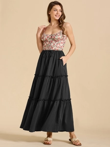 Detail of tiered black maxi skirt with elastic drawstring waist and side pockets