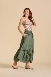 Detail of high waist adjustable drawstring on dark green maxi skirt with tiered hemline
