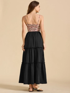 Detail of red floral spaghetti strap top with elastic smocked back and tiered black skirt