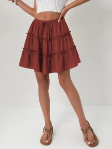 Detail of high-waisted rust red tiered mini skirt with adjustable drawstring and lining