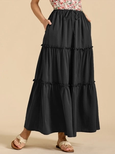 Detailed view of black tiered maxi skirt with elastic drawstring waist and layered design