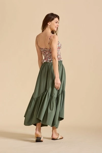 Detail view of olive green tiered bohemian skirt and smocked floral crop top ensemble