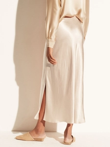 Champagne satin midi skirt with side slit shown from back view on model