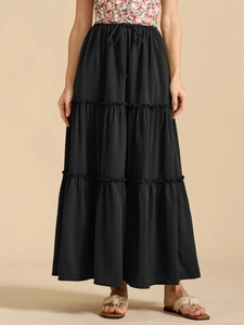 Detailed view of high waisted elastic waistband and adjustable drawstring on black maxi skirt