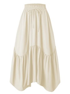Detailed view of cream maxi skirt featuring elastic high waist and wavy ruffle hemline