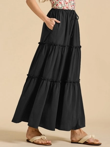 Detail view of high waisted black tiered maxi skirt with elastic waistband and drawstrings