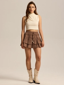 Detail of high waisted brown tiered skort with drawstring tassels and elastic waist