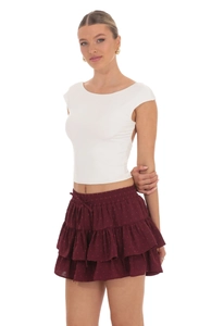 Detailed view of layered burgundy chiffon skirt with texture and side tie-up waist design