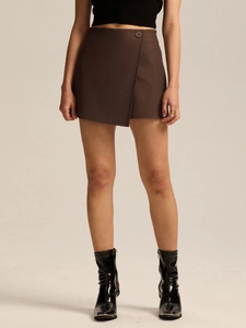 Detail view of brown wrap skort with asymmetrical front panel and button closure
