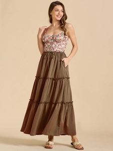 Detail of high waist brown tiered maxi skirt with adjustable drawstring and red floral top