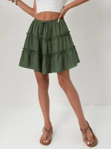 Detail of dark green tiered mini skirt showing layered ruffles and adjustable drawstring