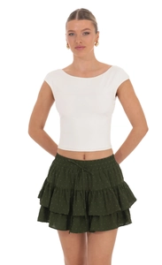 Detail of high waist adjustable drawstring on green polka dot tiered ruffled mini skirt