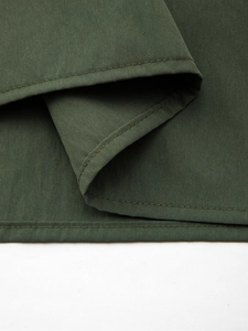 Close-up of olive green skirt showing precise stitching and durable cotton fabric texture