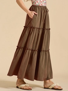 Detail view of olive brown tiered maxi skirt with high elastic waist and adjustable drawstring