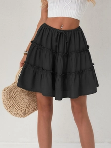 Detail of black multi-layered tiered mini skirt featuring adjustable drawstring waist
