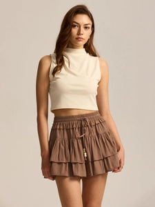 Detail of high waisted tiered skort with adjustable drawstring and decorative beads